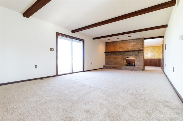 unfurnished living room featuring a fireplace, light carpet, and beamed ceiling