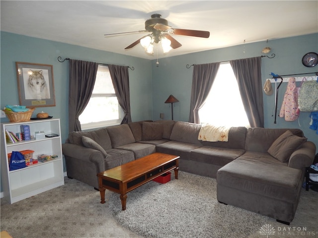 carpeted living room with ceiling fan