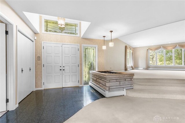 entryway featuring high vaulted ceiling and a chandelier