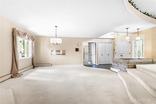 unfurnished living room featuring carpet flooring, baseboard heating, and a notable chandelier