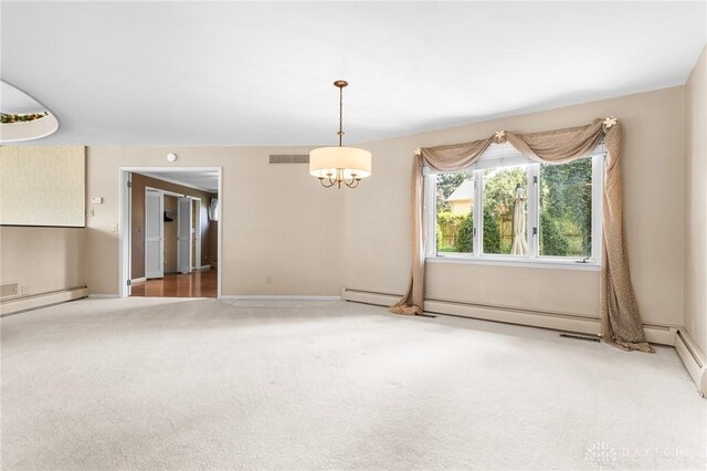 carpeted spare room with baseboard heating and an inviting chandelier