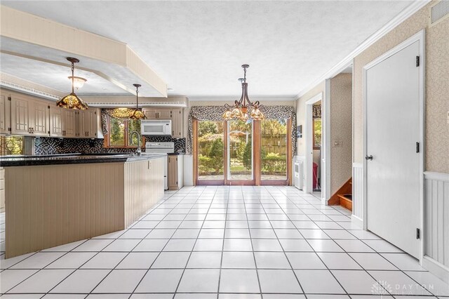 kitchen with ornamental molding, tasteful backsplash, light tile patterned floors, and hanging light fixtures