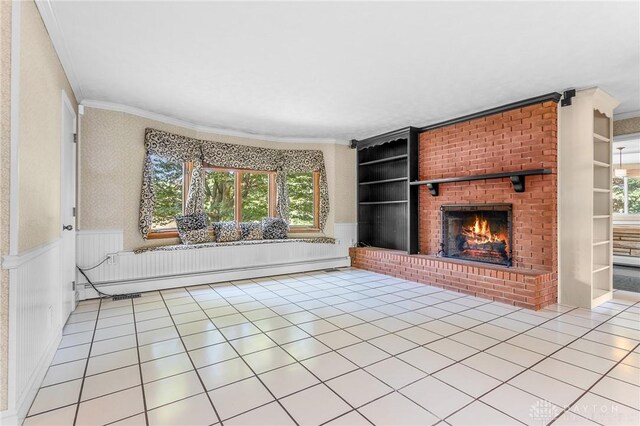 unfurnished living room featuring a fireplace, built in shelves, plenty of natural light, and light tile patterned floors