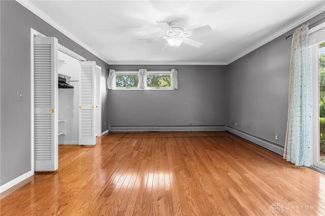 unfurnished bedroom featuring multiple windows, crown molding, and light hardwood / wood-style flooring