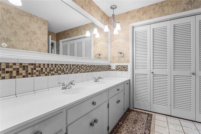 bathroom with tile patterned flooring, vanity, tile walls, and backsplash