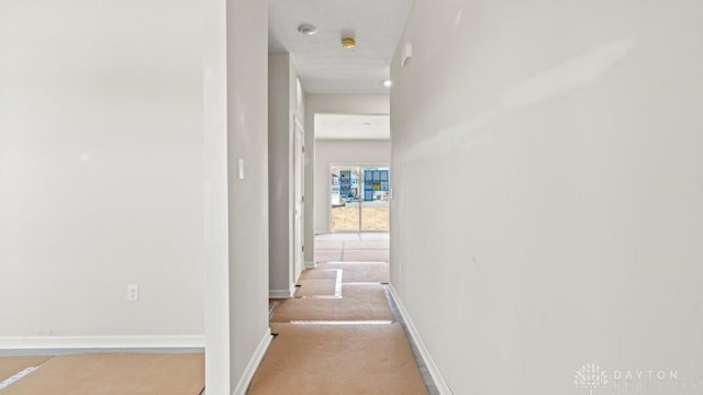 hall featuring baseboards