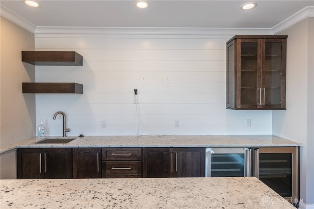 kitchen with light stone counters, glass insert cabinets, ornamental molding, open shelves, and a sink