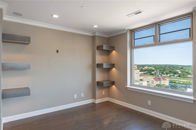 spare room with visible vents, baseboards, dark wood-style floors, ornamental molding, and recessed lighting