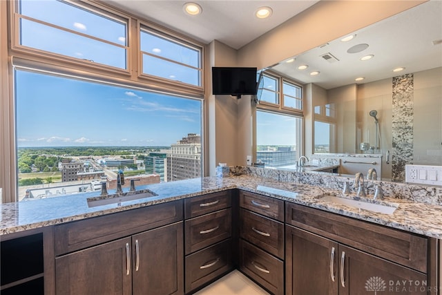 bathroom with recessed lighting, visible vents, a shower stall, and vanity