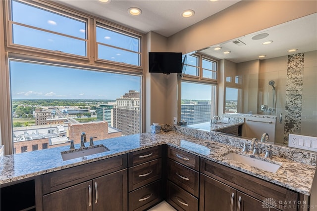 bathroom with a stall shower, a sink, and recessed lighting