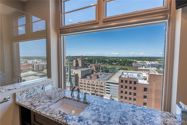 interior space featuring plenty of natural light, a view of city, and a sink