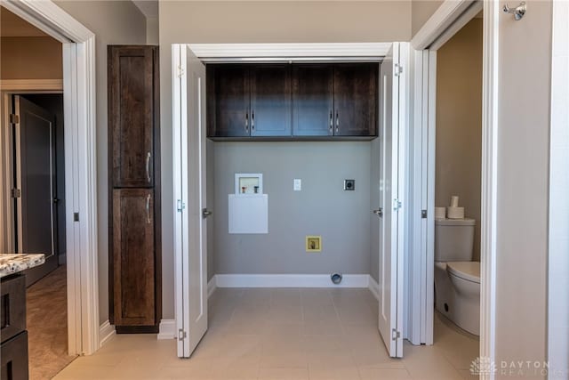 clothes washing area with cabinet space, hookup for a washing machine, baseboards, and hookup for an electric dryer