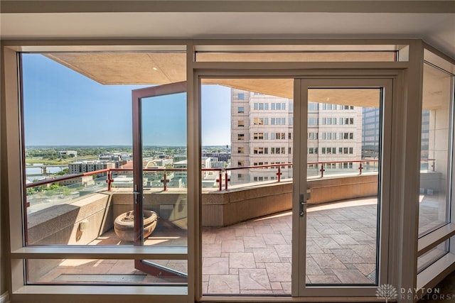 doorway to outside with a view of city and stone finish flooring