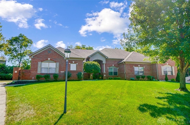 ranch-style home with a front lawn