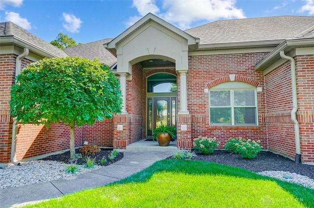 doorway to property with a yard