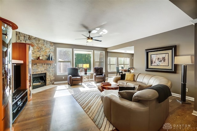 living room with ceiling fan, dark hardwood / wood-style floors, and a fireplace