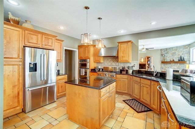 kitchen with wall chimney exhaust hood, a fireplace, appliances with stainless steel finishes, sink, and ceiling fan