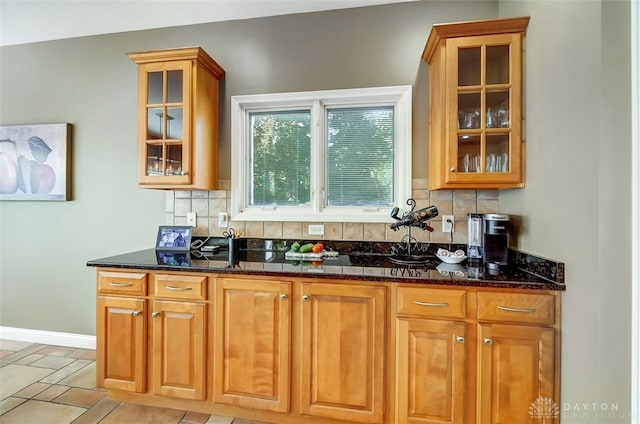 kitchen with dark stone counters and decorative backsplash