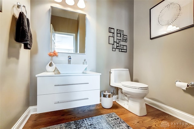 bathroom featuring vanity, toilet, and hardwood / wood-style floors