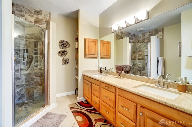 bathroom featuring tile patterned flooring, vanity, and walk in shower