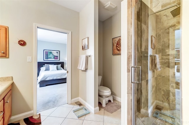 bathroom featuring vanity, toilet, a shower with shower door, and tile patterned flooring