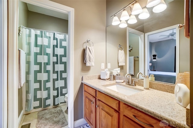 bathroom featuring vanity, toilet, ceiling fan, and tile patterned floors