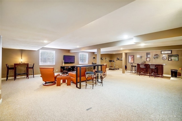 carpeted living room with indoor bar