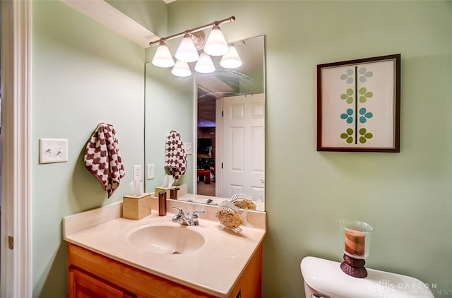 bathroom featuring toilet and vanity