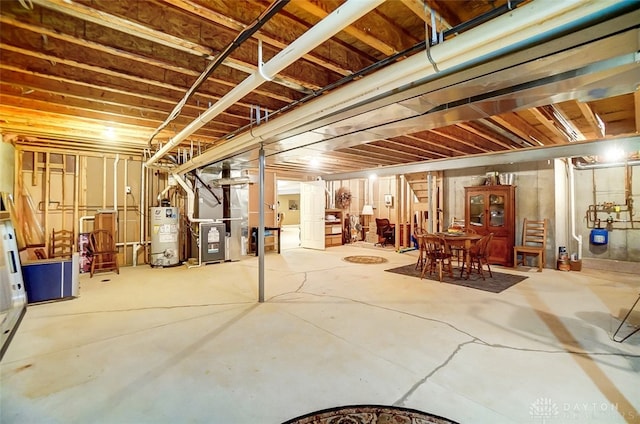 basement featuring heating unit and water heater