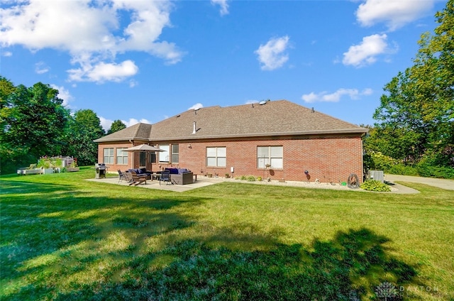 rear view of house with a lawn and a patio area