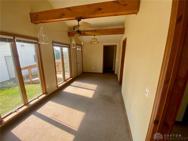 unfurnished sunroom with ceiling fan and beamed ceiling