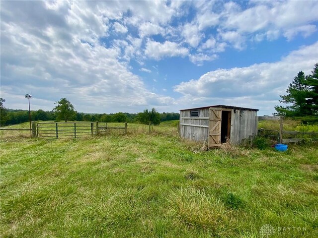 view of yard with a rural view and a shed