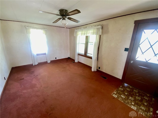 carpeted entrance foyer with ceiling fan