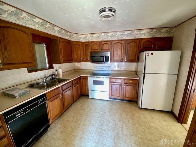 kitchen with white appliances, backsplash, and sink