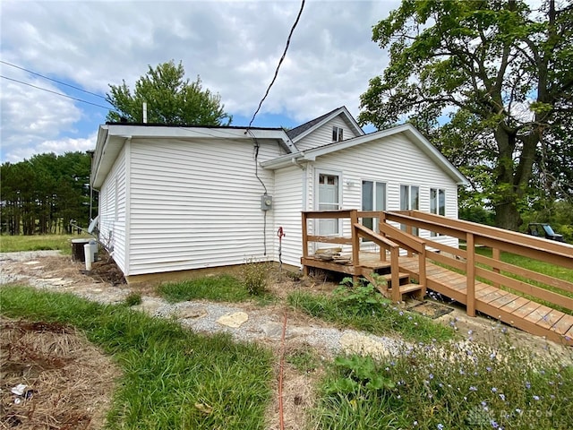 rear view of property with a wooden deck