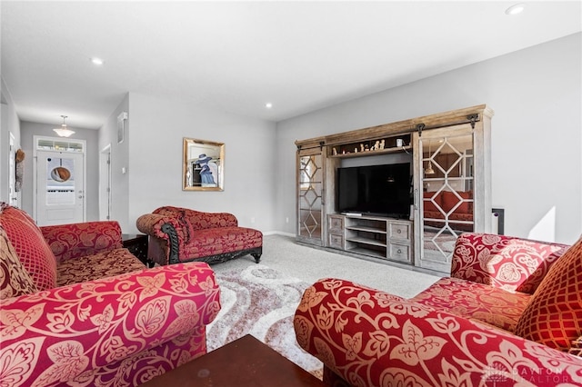 carpeted living room with a barn door