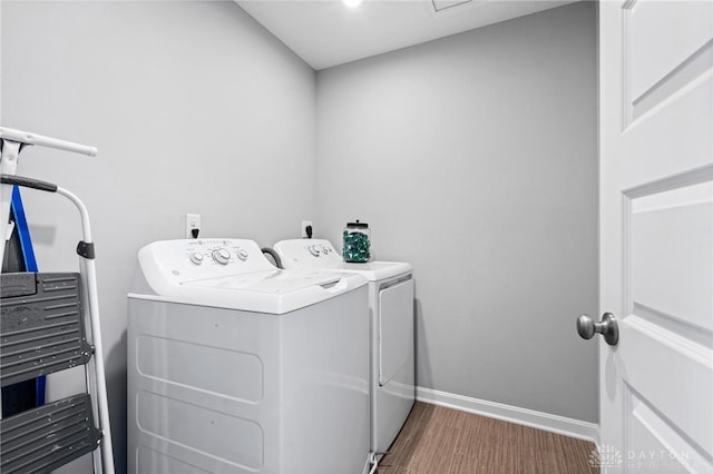 clothes washing area with washing machine and dryer