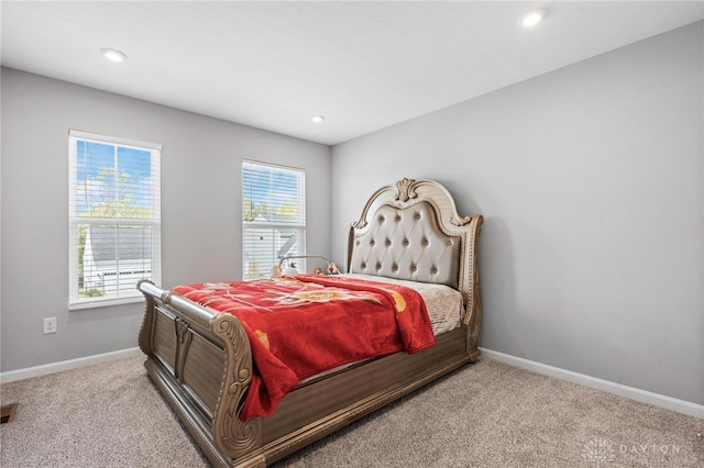 bedroom featuring light colored carpet