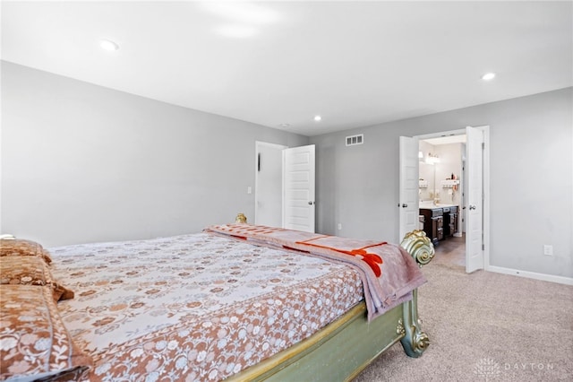 bedroom featuring carpet flooring and ensuite bathroom