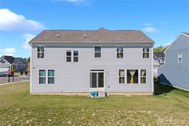 back of house featuring a lawn