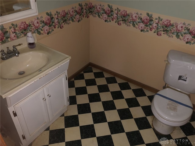 bathroom featuring toilet and vanity