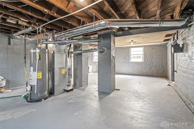 basement featuring heating unit and water heater