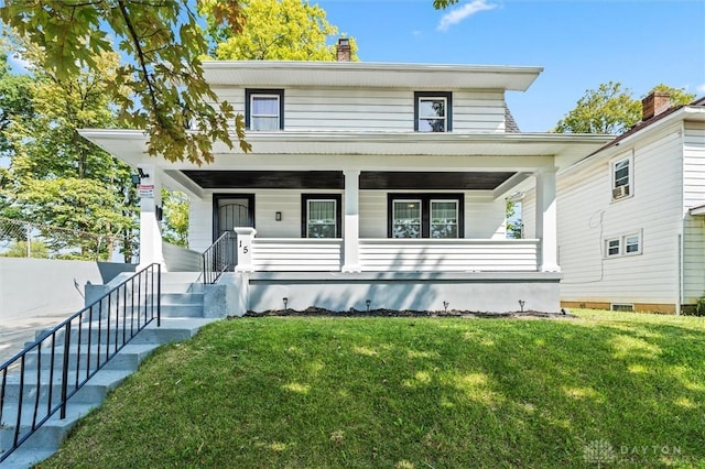 view of front of home with a porch and a front yard