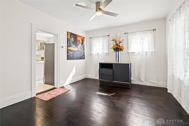 spare room with ceiling fan and dark hardwood / wood-style flooring