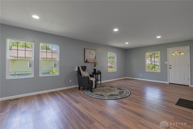 unfurnished room featuring a wealth of natural light and hardwood / wood-style flooring