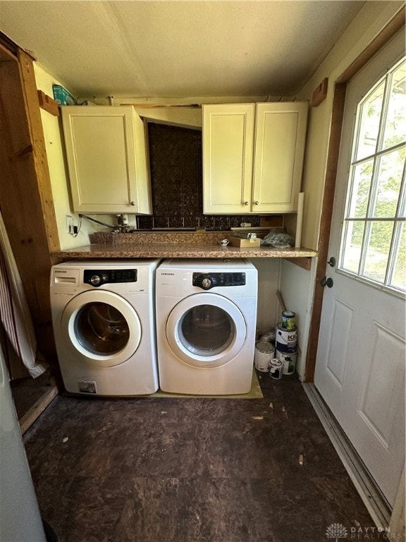 laundry room featuring washer and dryer and cabinets