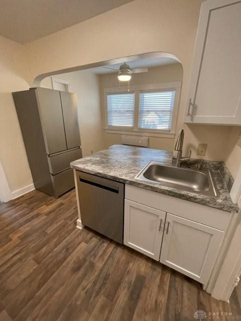 kitchen featuring white cabinetry, dark hardwood / wood-style flooring, dishwasher, stainless steel refrigerator, and sink