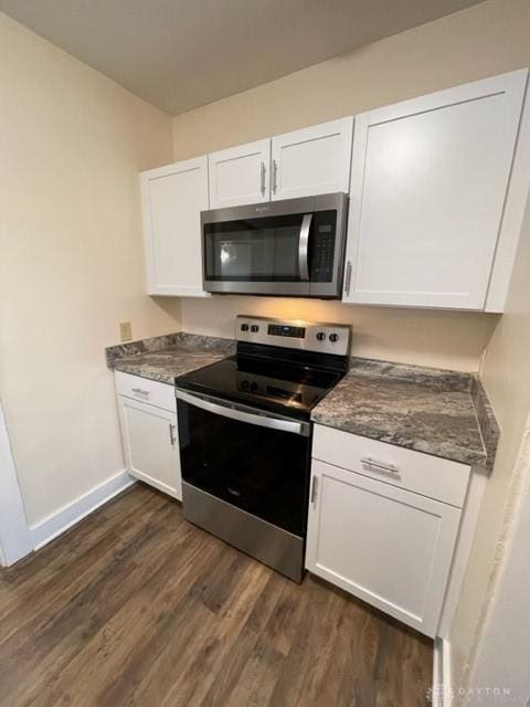 kitchen featuring dark hardwood / wood-style flooring, stainless steel appliances, and white cabinetry