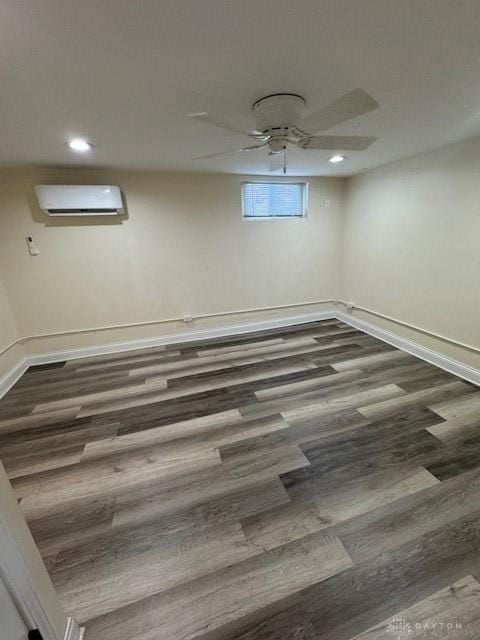 empty room with a wall mounted AC and dark hardwood / wood-style floors