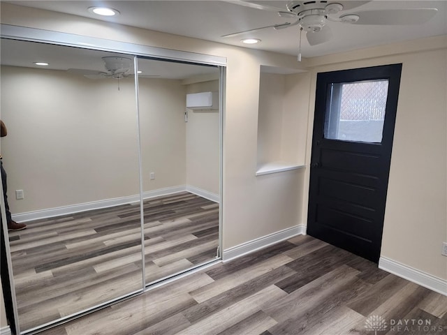 foyer with ceiling fan and dark hardwood / wood-style flooring